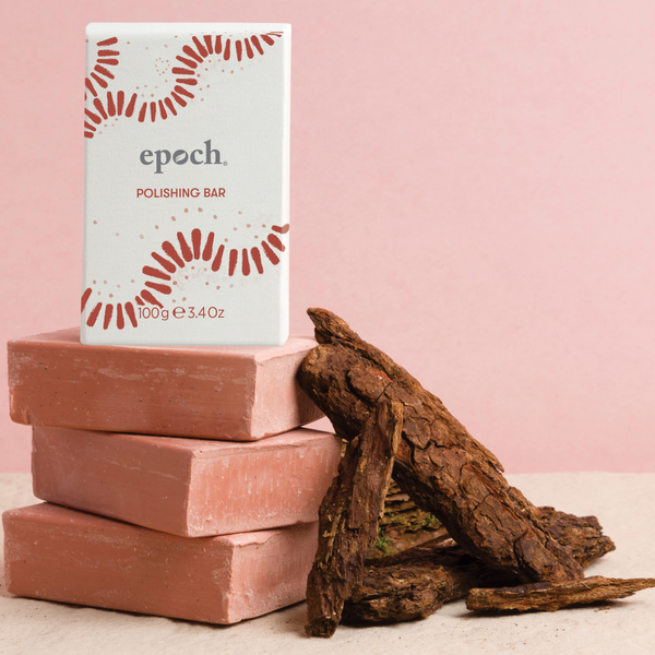 An Epoch Polishing Bar package standing on three other Epoch Polishing Bars with some sisku pas bark.